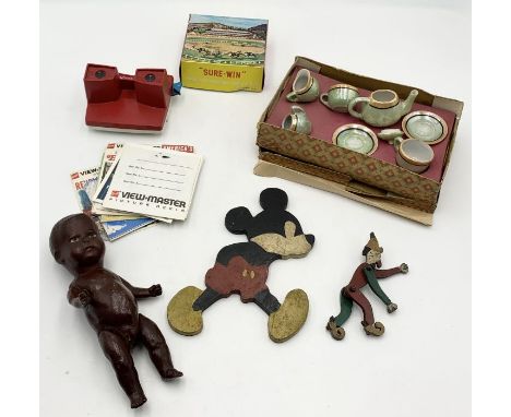 A small collection of vintage toys including a jointed doll, Mickey Mouse wooden figure, a View-Master and Sure-Win game, toy