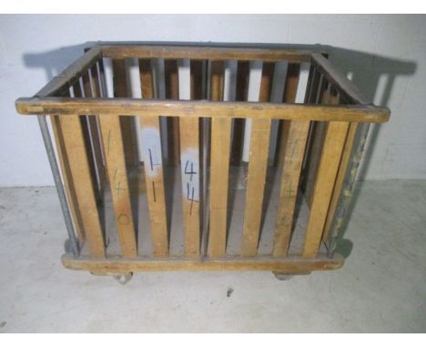 A slatted wooden industrial bobbin trolley