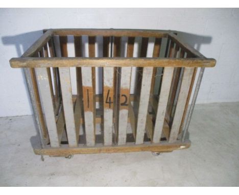 A wooden slatted industrial bobbin trolley