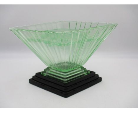 An Art Deco green glass vase on plinth