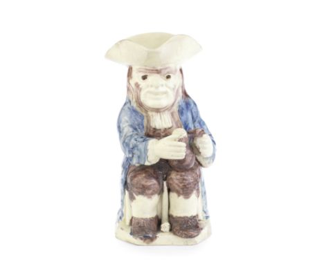A creamware 'Step' Toby jug, circa 1780-85Modelled seated, holding a foaming jug in his left hand, his right hand slightly ra