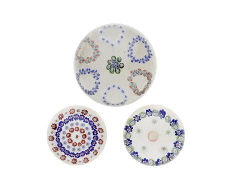 Three French millefiori paperweights, circa 1850Comprising a Baccarat concentric weight, the central stardust cane within fou