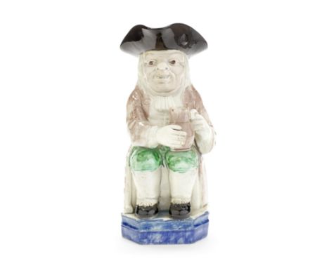 A Staffordhire pearlware 'Double Base' Toby Jug, circa 1790Of traditional form and seated on a rare 'Double Base' washed in b