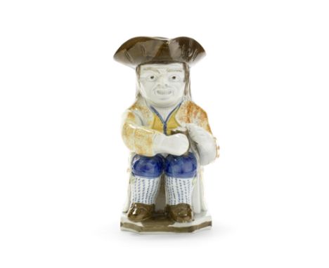 A Prattware 'Askew' Toby Jug, circa 1810Of traditional form, seated with a pipe resting on the base to his right and balancin