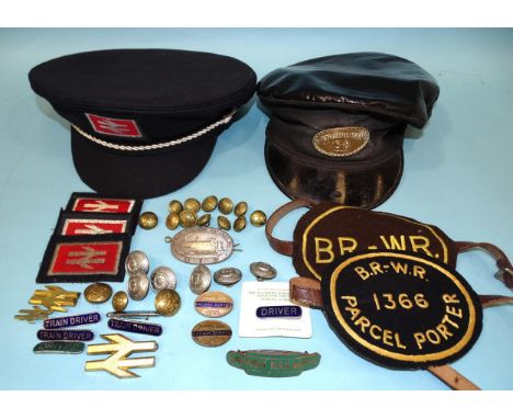 A Great Western Railway Co. metal cap badge, an "Engine Man SR" badge on a grease-top cap (1964), a "British Railways" enamel