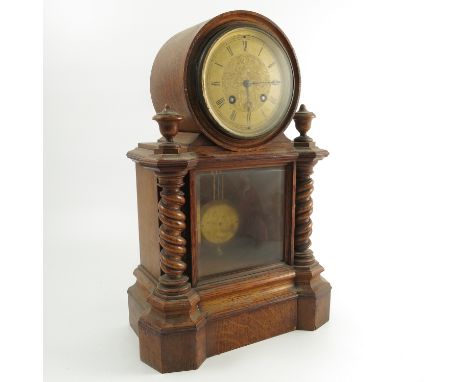 A 19th century oak cased mantel clock, the striking drum movement (bell missing) with gilt engraved dial, the case with glaze