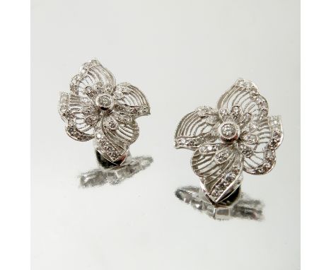 A pair of diamond ear clips, stamped '18k' and '750', the diamonds to an openwork white mount, diamonds totalling approximate