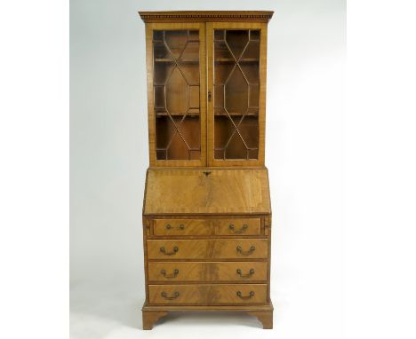 A Georgian design mahogany bureau bookcase, having an astragal glazed door with a fitted interior and having four graduated l