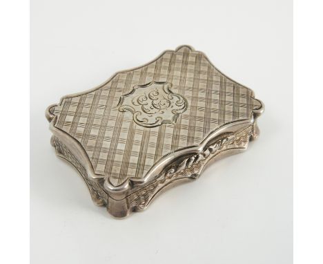 A Victorian silver vinaigrette, of shaped rectangular form with engine turned decoration to the case and engraved pierced gri