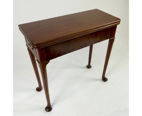 A Georgian style mahogany slender games table, with fold over top fitted with an end drawer, with gate leg action, raised on 