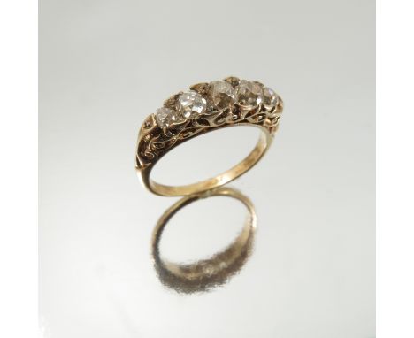 A fire stone diamond ring, circa 1900, the graduated old cuts totalling approximately 0.65 carats, with rose diamond points b