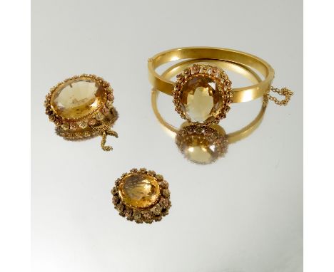 A Victorian citrine demi-parure, stamped '15ct', the hinged bangle also marked 'T.L.& S' and 'Patent Bolt Snap', the oval cut