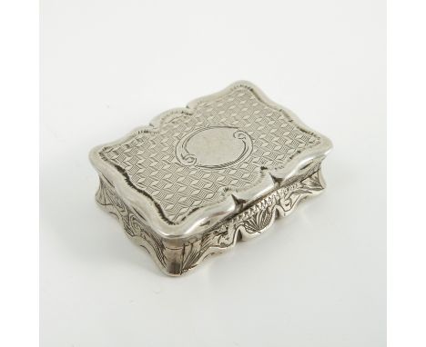 A Victorian silver vinaigrette, of shaped rectangular form, with engine tuned decoration to the case and engraved pierced gri