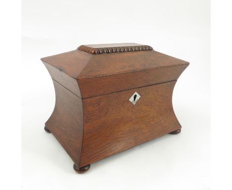 A 19th century rosewood tea caddy, the interior fitted with two covered compartments, raised on oblate bun feet, width 8ins