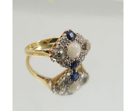 An opal, sapphire and diamond cluster ring, the round cabochon with an old brilliant cut to either side, totalling approximat