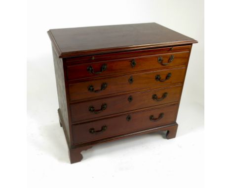 A Georgian style mahogany chest, of four graduated long drawers with well cast handles below a brushing slide, raised on brac