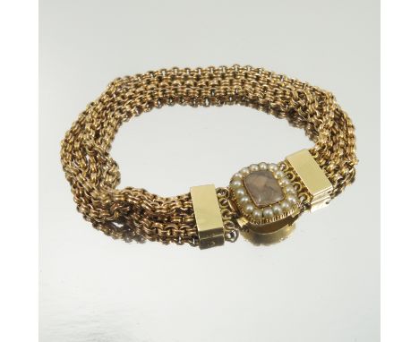A Victorian bracelet, with split pearl border hair locket clasp, composed of four reeded belcher link strands, unmarked, 22g 