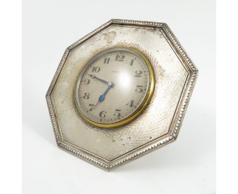 A silver cased eight day clock, the octagonal case with engine turned decoration, London 1904, maker Goldsmith and Silversmit