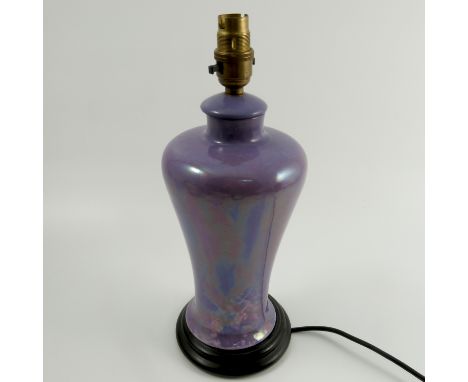 A Ruskin Pottery lamp base, of baluster form, decorated in a purple lustre glaze, dated 1916, on a wooden base, height includ