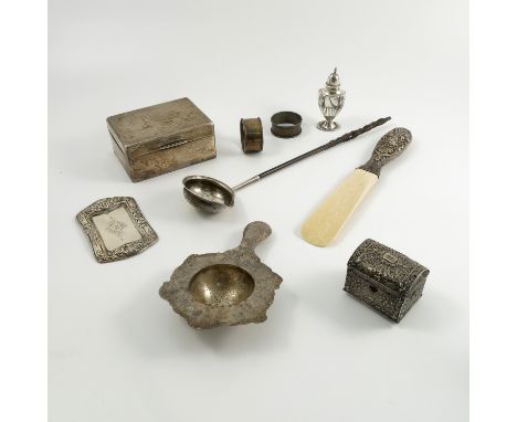 A collection of hallmarked silver, to include a cigarette box with engine turned decoration, a silver handled and ivory shoe 