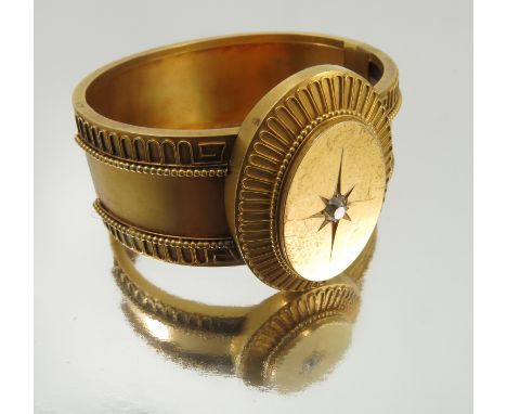 A Victorian diamond set gold hinged bangle, unmarked, circa 1880, the oval head star set with an old cut of approximately 0.2