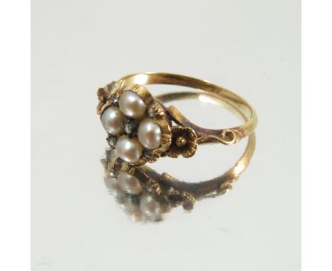 A Victorian split pearl and rose diamond ring, of flower head shape, with floral shoulders, glazed locket back, finger size K