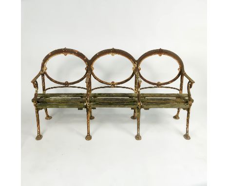 An iron triple chair back garden bench, with oval shaped back and wooden slatted seats, stamped W MacFarlane & Co. Glasgow, w