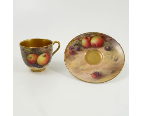 A Royal Worcester cabinet cup and saucer, the exterior of the cup and the saucer decorated with fruit to a mossy background b