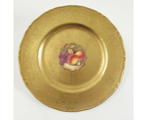 A Royal Worcester cabinet plate, hand painted to the centre with fruit to a mossy background by R Price, with deep acid gilt 