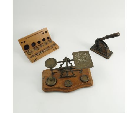 An Inland Letter Post set of postal scales, the brass scales mounted on a shaped mahogany base with recesses for the weights,