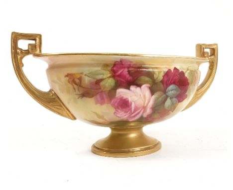 A Royal Worcester oval pedestal bowl, with a pair of gilt handles, hand painted with roses by Sedgley, raised on an oval gilt