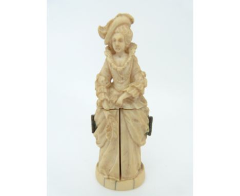 A 19thC Dieppe ivory figure, possibly Marie Antoinette, opening to reveal carved scenes including a man painting her portrait