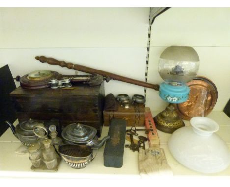 A wooden chest containing a selection of vintage tools together with an aneroid barometer, oil lamp, silver plated tea set, c