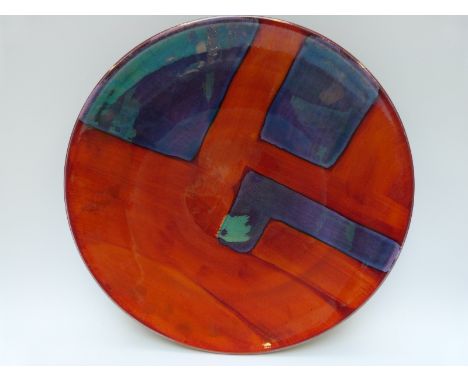 A large Poole pottery charger decorated with a geometric design, 40cm diameter