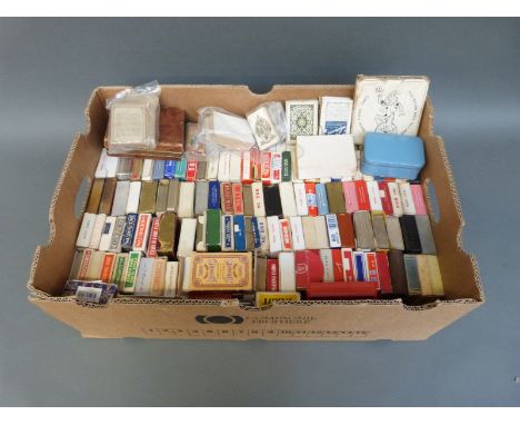 A collection of approximately 150 packs of playing cards to include Victorian, Bezique, circular examples etc 