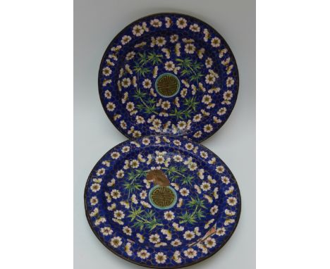 A pair of 19thC Chinese enamel on copper plates decorated with prunus blossom and bamboo on blue ground, old labels to base, 