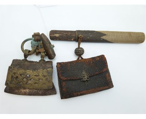 Two Japanese purses, one with brass fittings the other with rat finial attached to an opium pipe