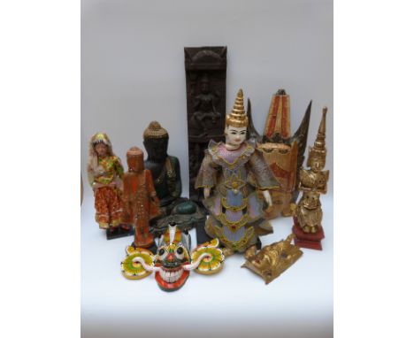 A collection of Thai and Indonesian items to include carved wood Buddhas, temple figure, puppet of a dancer, Indian doll and 