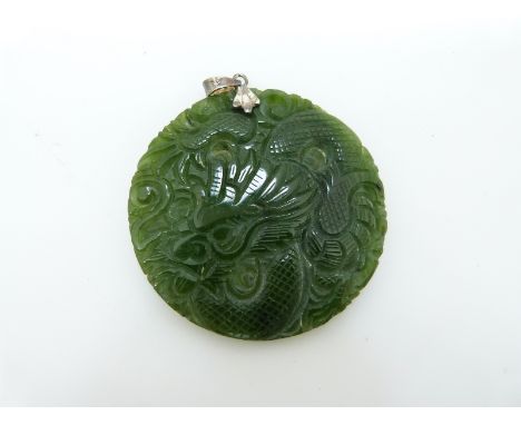 A carved nephrite jade pendant in the form of a dragon, verso a phoenix, 4.9cm 
