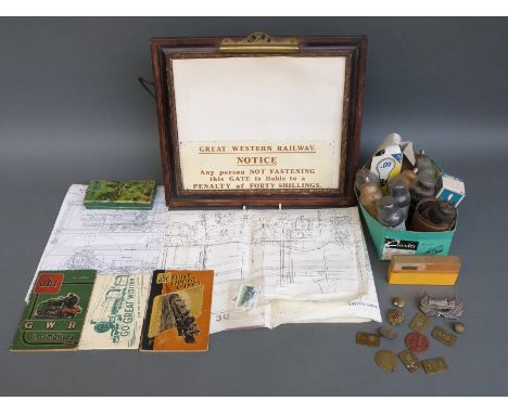 A quantity of largely GWR railwayana including pay tokens, buttons, badge, brass toilet roll holder mounted on picture frame,