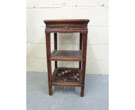 A Chinese side table with a pierced shelf below and single drawer, 76cm tall