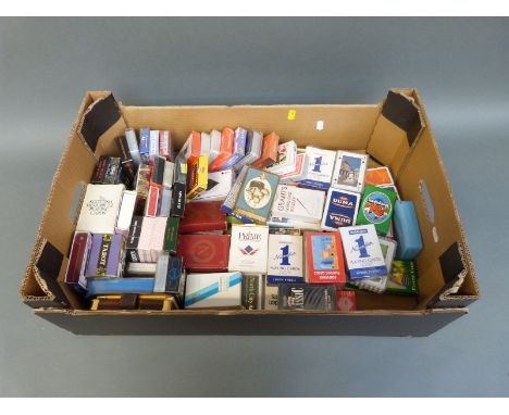 A collection of approximately 70 packs of playing cards to include Grants Whiskey, Mayflower commemoration, souvenir examples