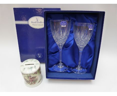 A pair of boxed cut glass Royal Doulton wine glasses and a Royal Worcester money box