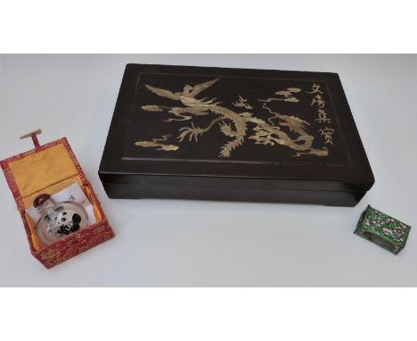 A Japanese hardwood box with inlaid mother of pearl decoration depicting a dragon chasing a flaming pearl, a Chinese enamel m