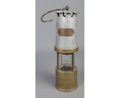 J.H Naylor of Wigan miners safety lamp with brass base and swing handle.