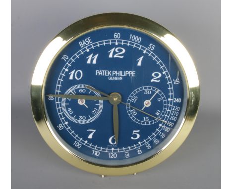 A Patek Philippe watch style wall clock, featuring a gold bezel and blue dial, quartz movement, diameter 40cm.