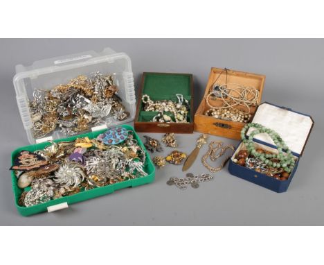 A large collection of vintage costume jewellery, including a box of assorted brooches and small jewellery boxes containing ne