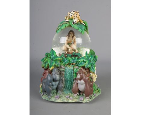 A Disney Tarzan snow globe in original box.Hx19cm
