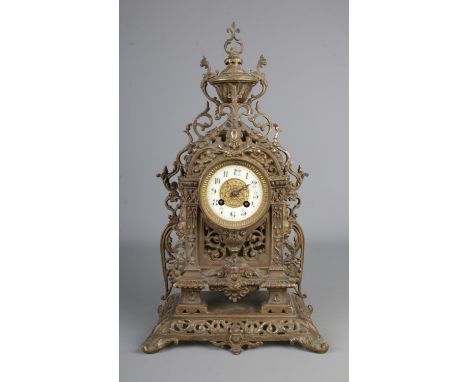 An ornate French cast brass mantle clock with cherub and dolphin decoration. Height 48cm.  No glass. One hand missing.