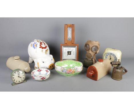 A collection of assorted items, to include reproduction child's gas mask, large ceramic piggy bank, Westclox clock and two ce